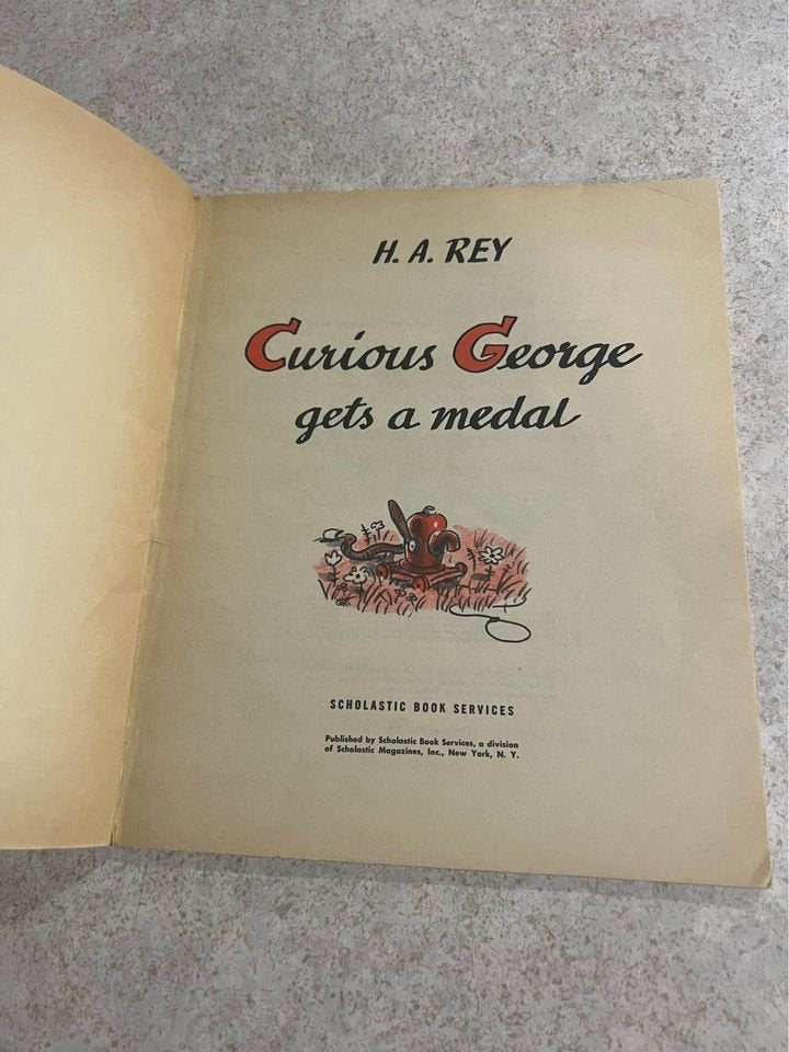 Curious George Gets A Medal by H. A. Rey Vintage Scholastic Paperback Book 1957 / 1967